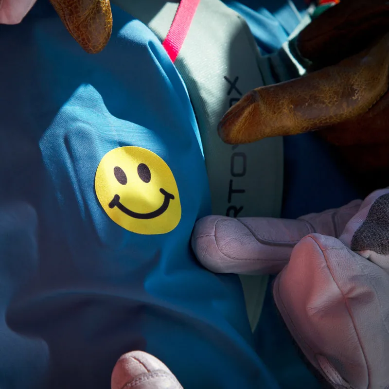 Just Smile Noso patch on a blue puffer