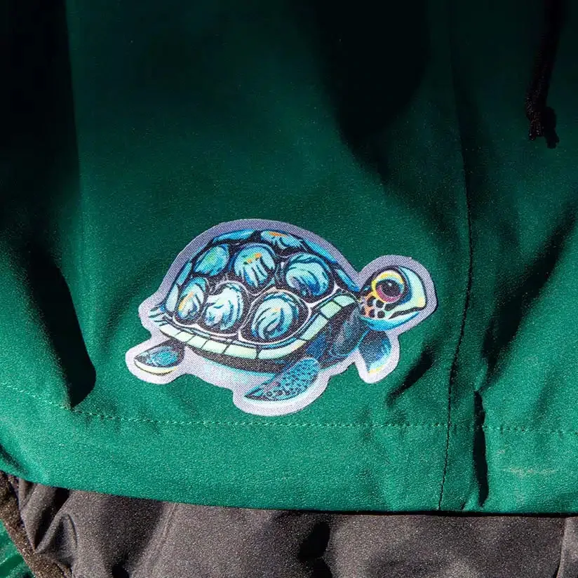 Turtle Noso patch applied to a green jacket